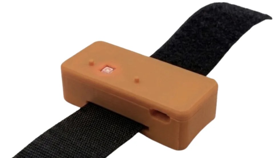 MamaPulse wrist-worn device with velcro strap and lit sensor indicator